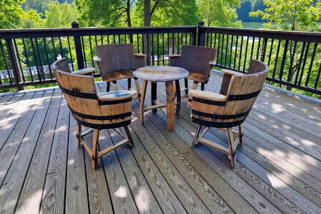 Whisky barrel armchairs and coffee table set on outdoor decking