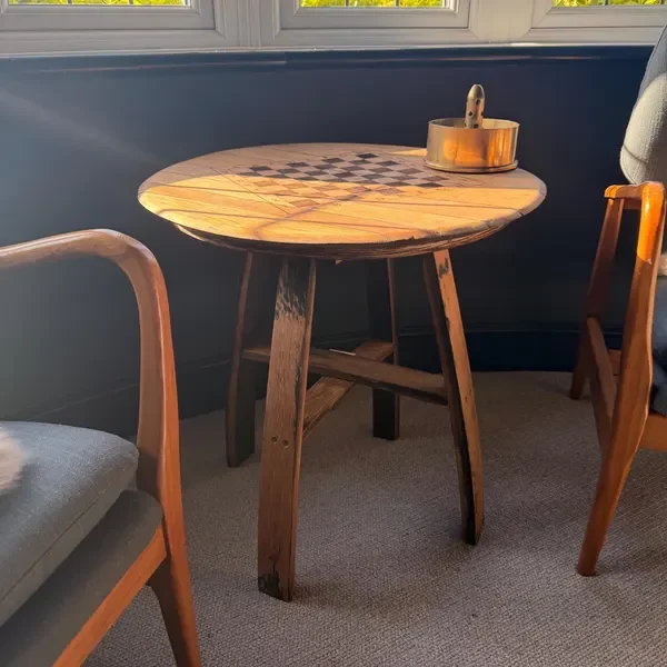 A barrel chess table in a customer’s room, photographed by Becca