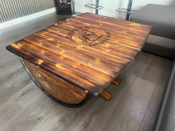 Customer photo of a personalised whisky barrel coffee table in a home bar