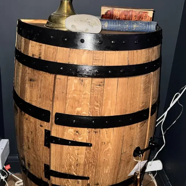 A half barrel cabinet in a blue-walled room, photographed by edward