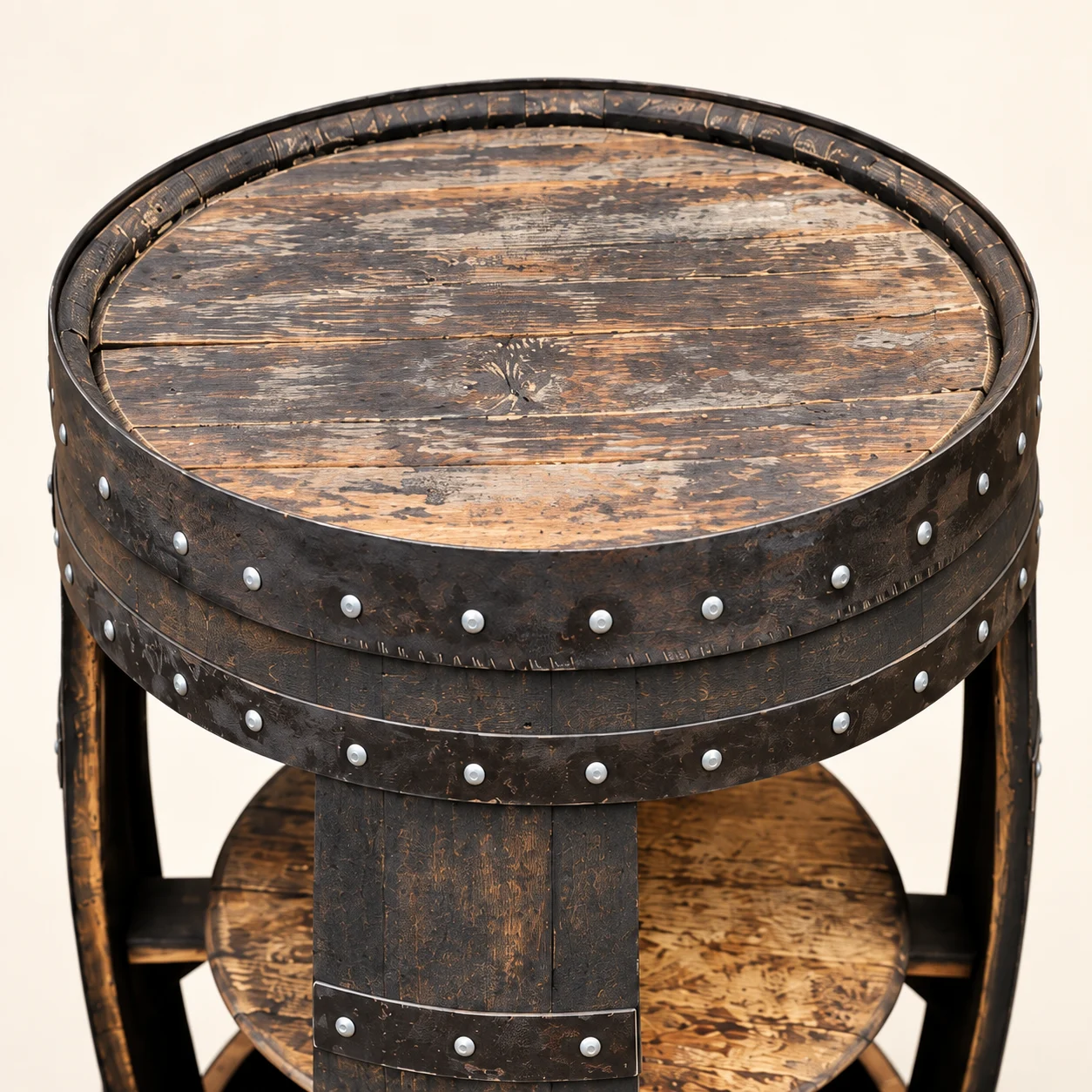 Close-up of the dark oak barrel table's inset wooden top and raised riveted rim