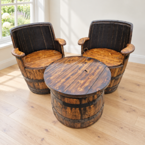 Two oak barrel armchairs and matching barrel coffee table in a bright garden room
